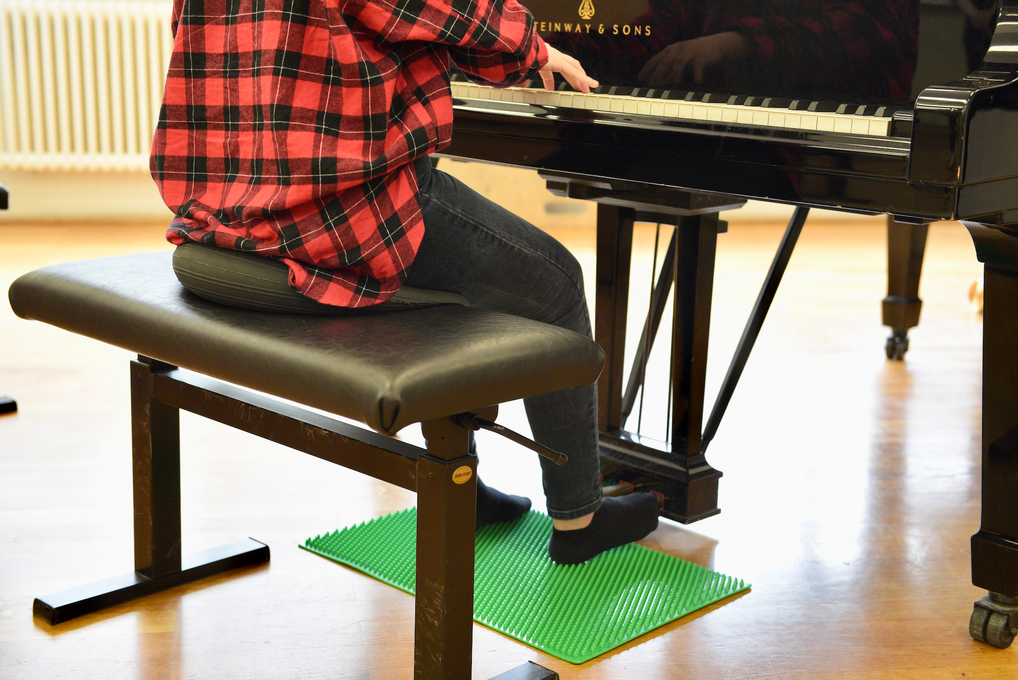 Using th studded rubber mat when playing the piano